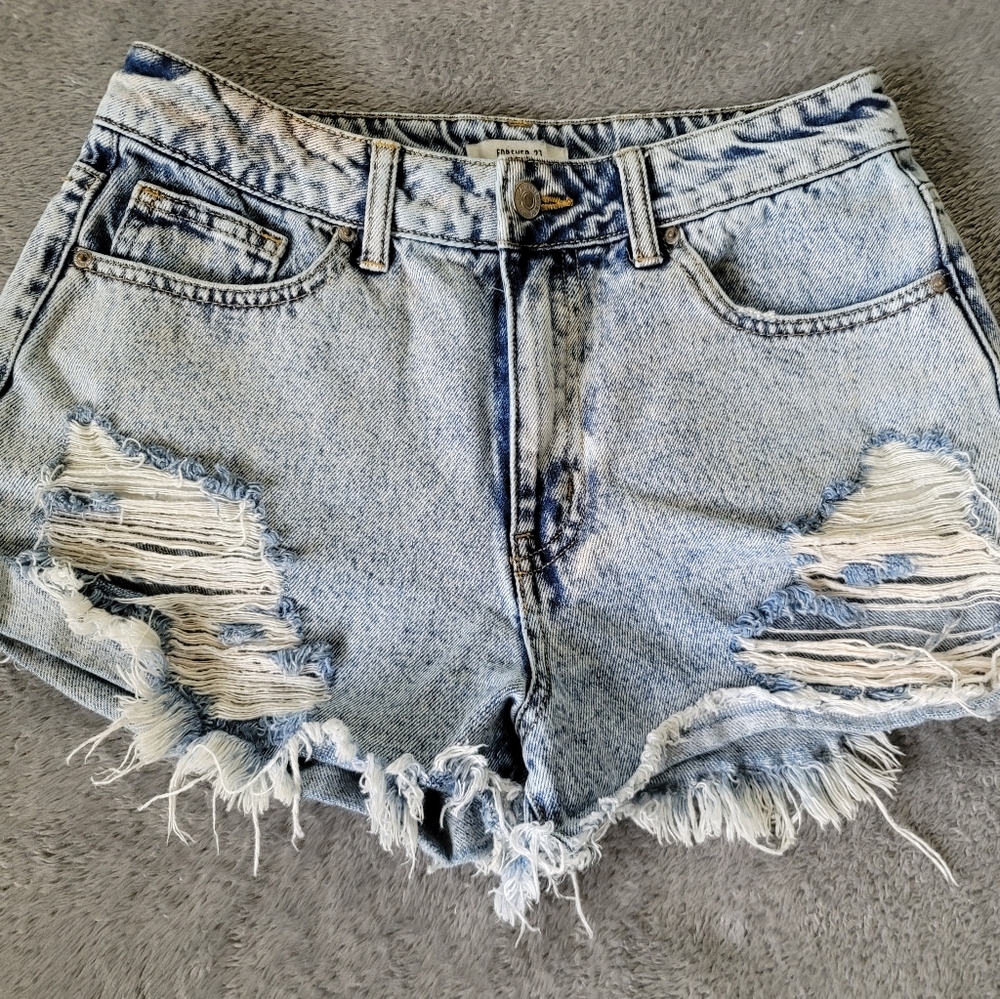 Factory distressed Jean shorts. Light acid wash. High waistline